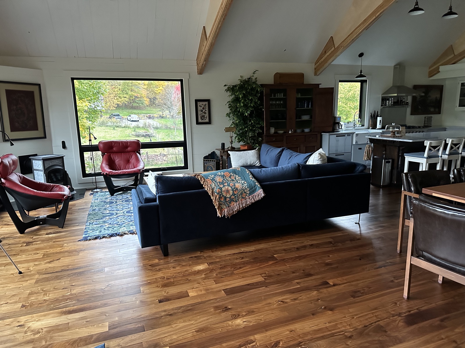 Living room with red chairs facing pasture window
