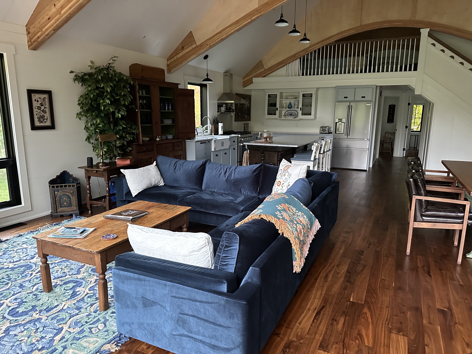 Barnhouse living room with blue sectional and woodstove