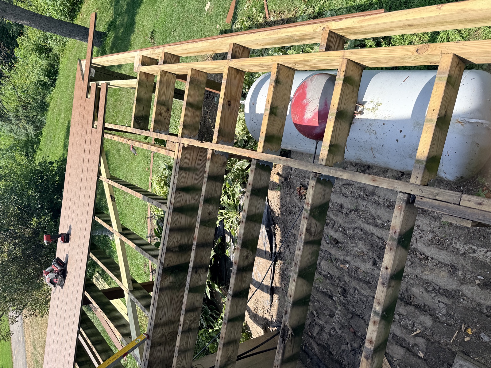 Deck framing over propane tank and driveway