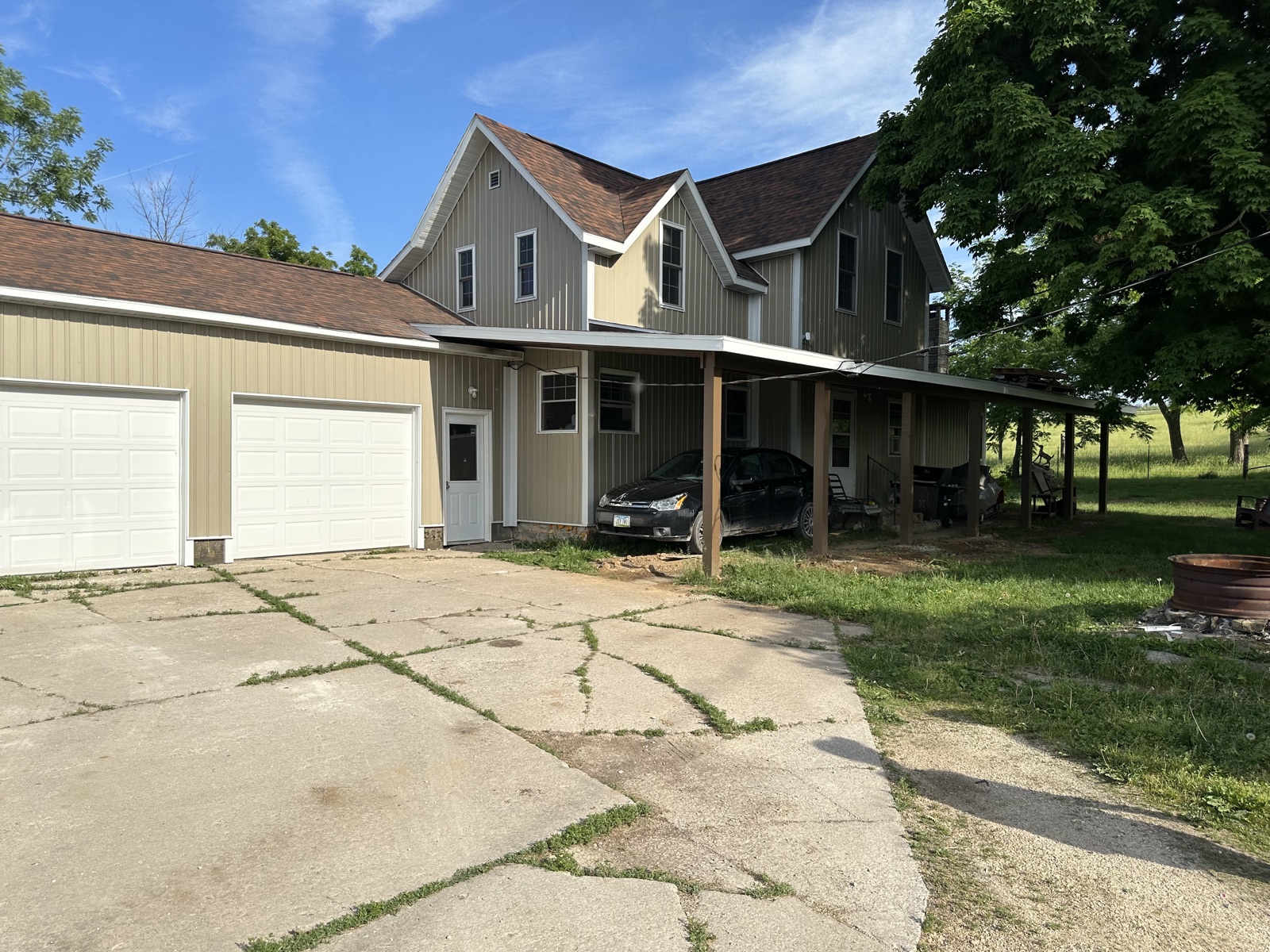 Green farmhouse with 3-car garage